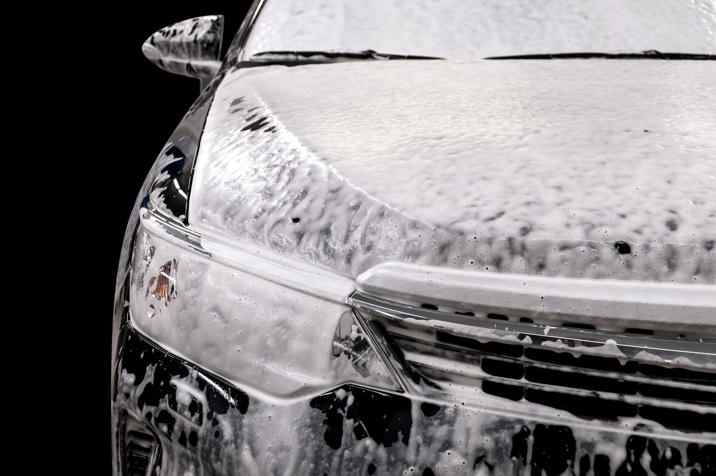 Car covered with cleaning foam